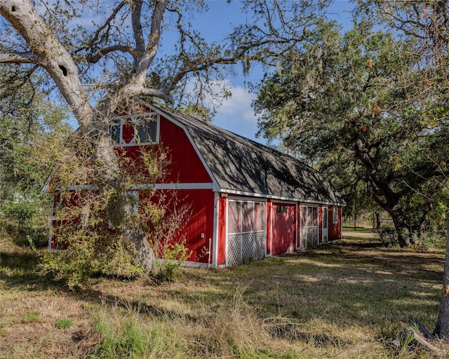 view of outbuilding with a lawn