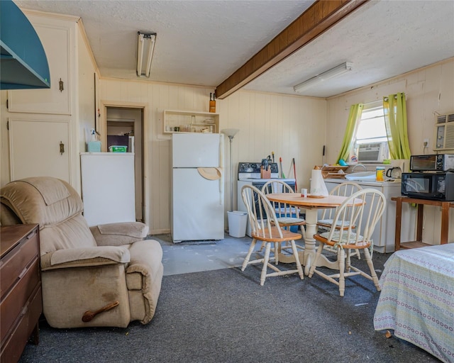 dining space with cooling unit, concrete floors, a textured ceiling, and washer / dryer