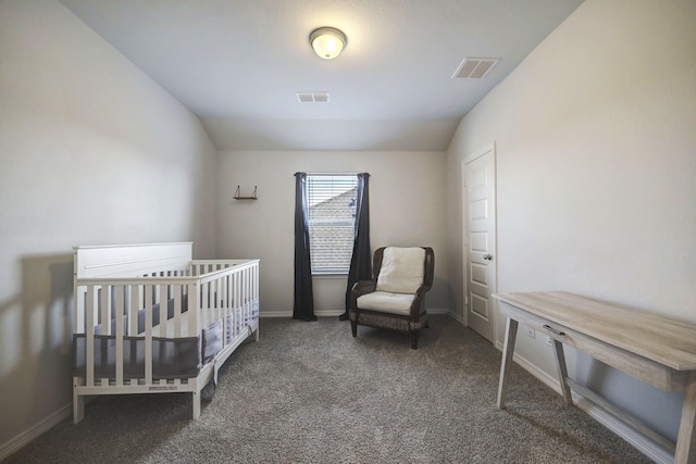 carpeted bedroom featuring a nursery area and lofted ceiling