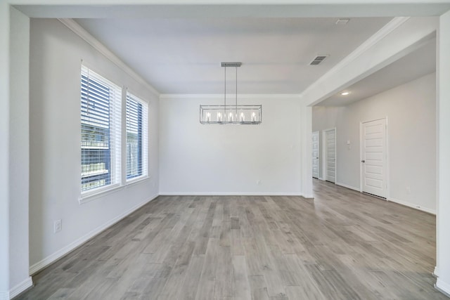 unfurnished dining area with a notable chandelier, light hardwood / wood-style floors, and ornamental molding