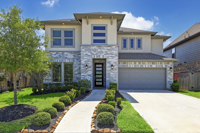 view of front of house featuring a front yard and a garage