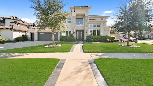 view of front of property featuring a garage and a front lawn