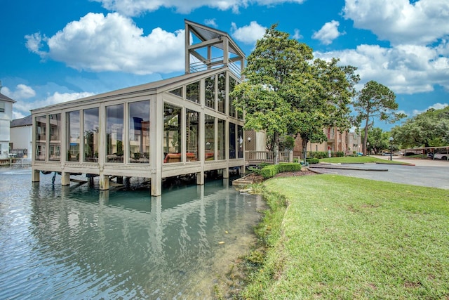 dock area featuring a lawn and a water view