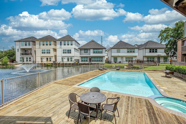 view of pool with an in ground hot tub and a deck with water view