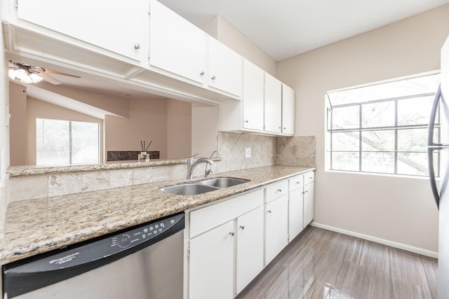 kitchen featuring dishwasher, decorative backsplash, white cabinetry, and sink