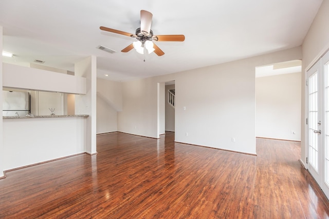 unfurnished living room featuring dark hardwood / wood-style floors, plenty of natural light, and ceiling fan