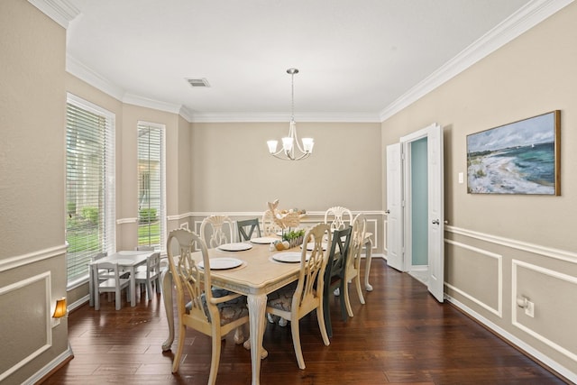 dining room with ornamental molding, a wealth of natural light, and an inviting chandelier