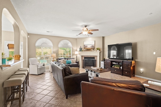 tiled living room with ceiling fan