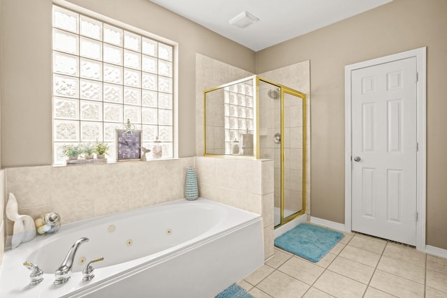 bathroom with separate shower and tub and tile patterned floors