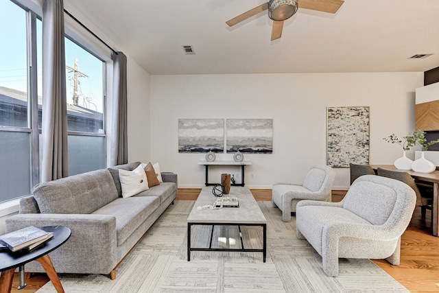 living room with ceiling fan and light wood-type flooring