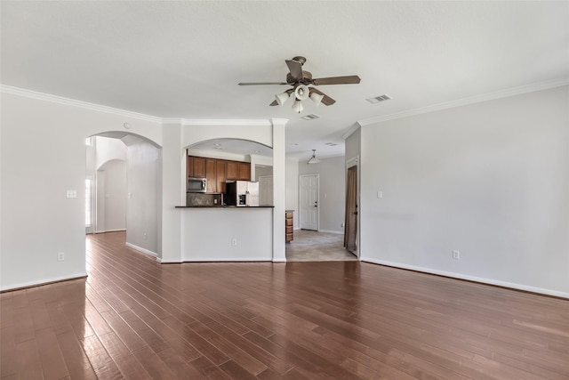 unfurnished living room featuring dark wood-type flooring, ceiling fan, and ornamental molding