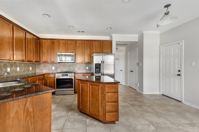 kitchen featuring sink, backsplash, appliances with stainless steel finishes, light tile patterned flooring, and ornamental molding