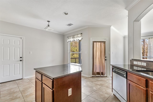 kitchen featuring a center island, crown molding, dishwasher, and light tile patterned floors