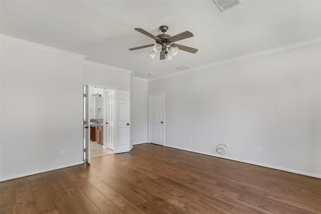 spare room featuring dark hardwood / wood-style flooring, ceiling fan, and crown molding