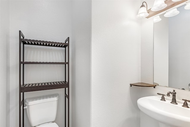 bathroom with toilet and sink