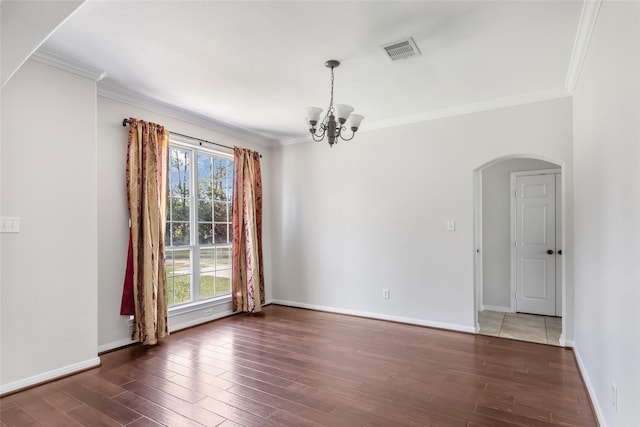 unfurnished room featuring ornamental molding, dark hardwood / wood-style flooring, an inviting chandelier, and a healthy amount of sunlight