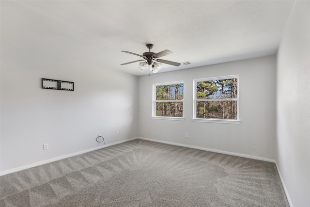 carpeted spare room featuring ceiling fan