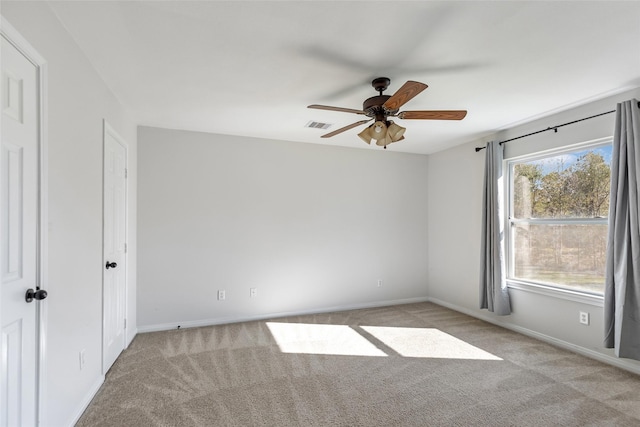 carpeted spare room with ceiling fan and a healthy amount of sunlight