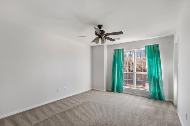 carpeted spare room with ceiling fan