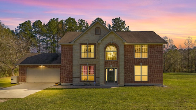 view of front of property featuring a garage and a yard