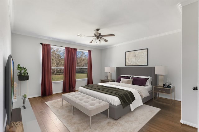 bedroom with ceiling fan, hardwood / wood-style floors, and ornamental molding