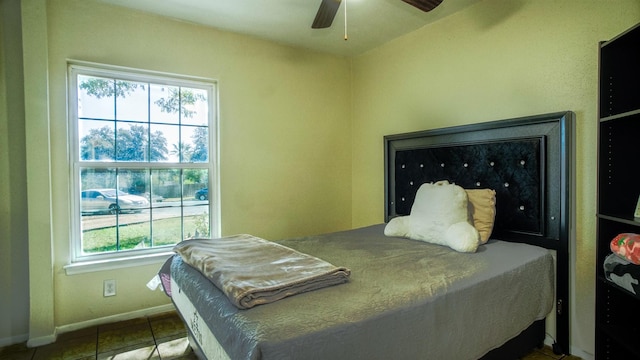 tiled bedroom with multiple windows and ceiling fan