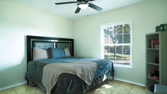 bedroom with ceiling fan and light tile patterned flooring