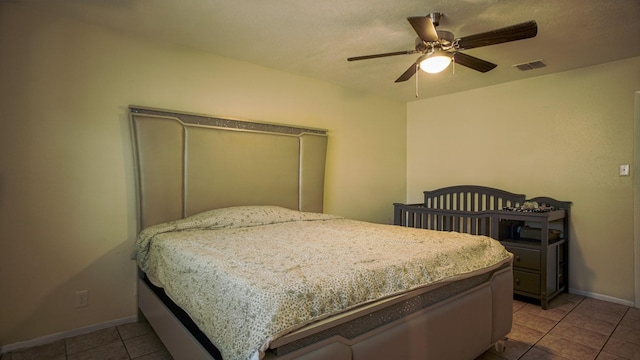 tiled bedroom featuring ceiling fan