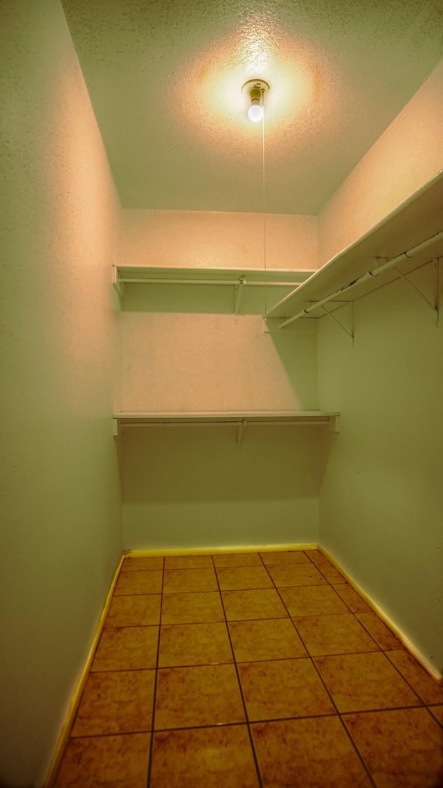 walk in closet featuring tile patterned flooring