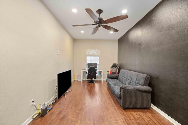 living room with light hardwood / wood-style floors and ceiling fan