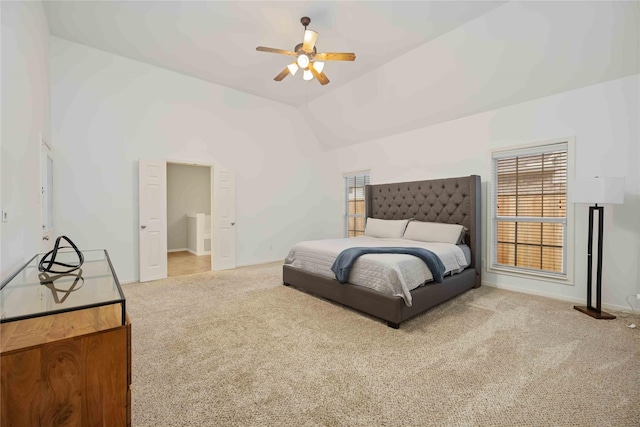 carpeted bedroom with ceiling fan and vaulted ceiling