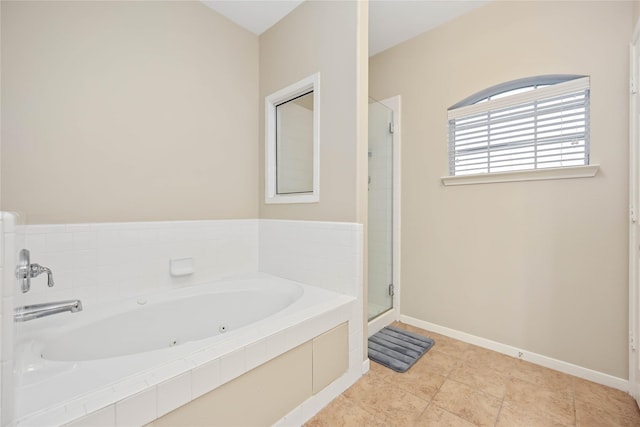 bathroom with tile patterned floors and independent shower and bath