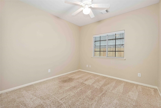 carpeted empty room featuring ceiling fan