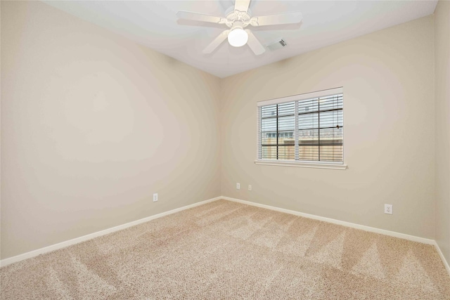 spare room with ceiling fan and carpet floors