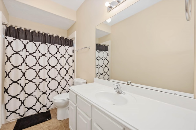 bathroom with tile patterned flooring, vanity, and toilet