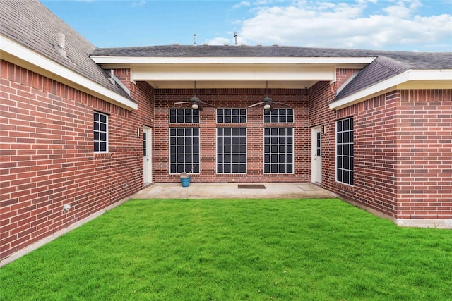 rear view of house featuring a lawn and a patio