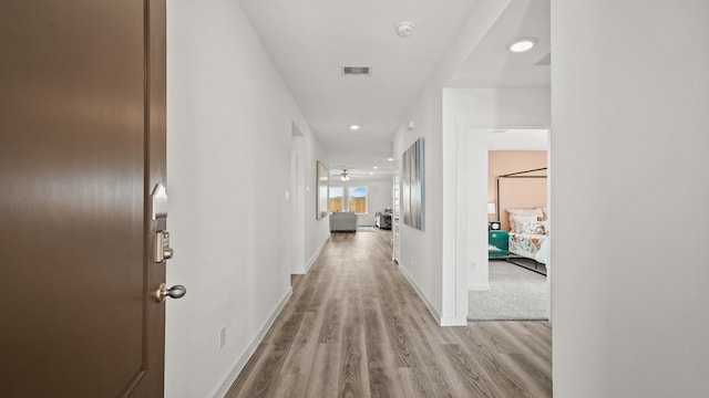 corridor featuring light hardwood / wood-style floors