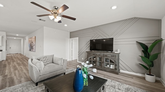 living room with hardwood / wood-style floors and ceiling fan