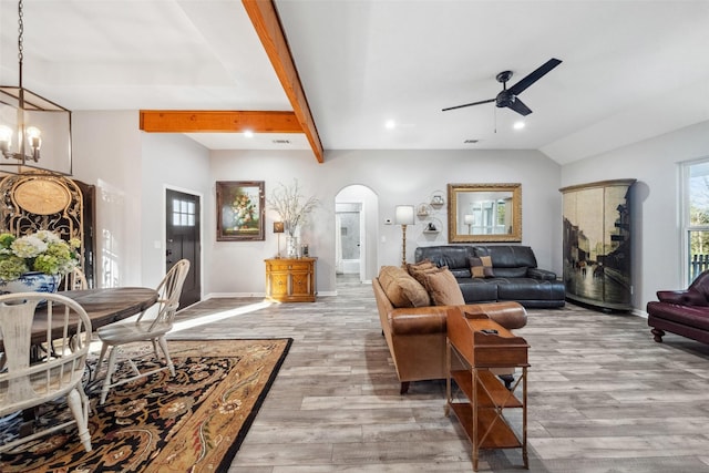 living room featuring ceiling fan, light hardwood / wood-style flooring, and beamed ceiling