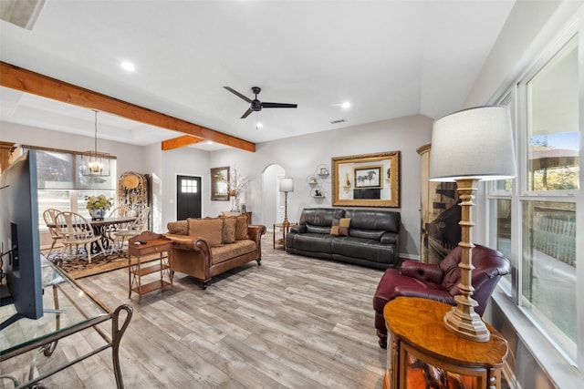 living room featuring ceiling fan with notable chandelier and light hardwood / wood-style floors