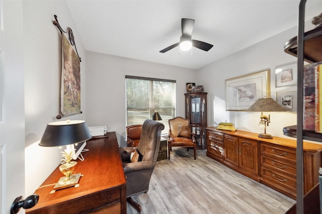 home office with ceiling fan and light hardwood / wood-style floors