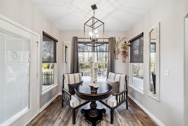 dining space featuring dark hardwood / wood-style floors and a notable chandelier