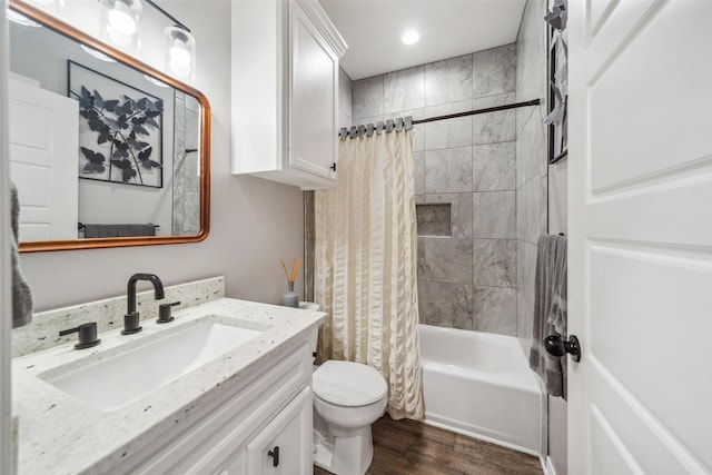 full bathroom with hardwood / wood-style flooring, shower / bath combination with curtain, toilet, and vanity