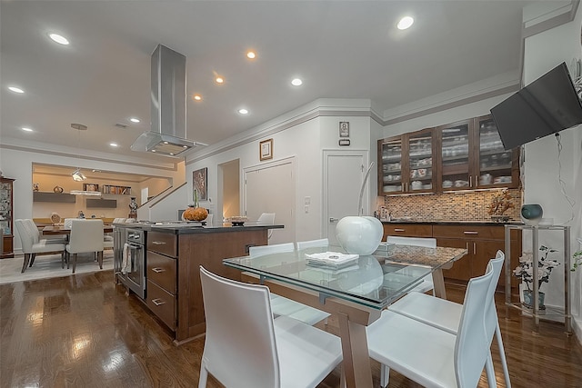 dining room with dark hardwood / wood-style flooring and ornamental molding