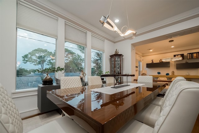 dining space with crown molding and an inviting chandelier