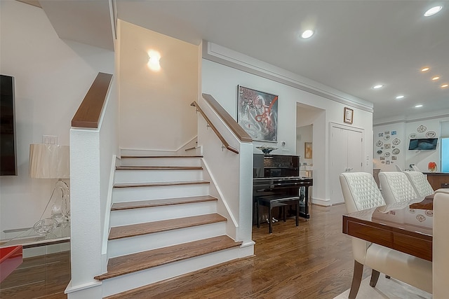 stairs with crown molding and hardwood / wood-style floors