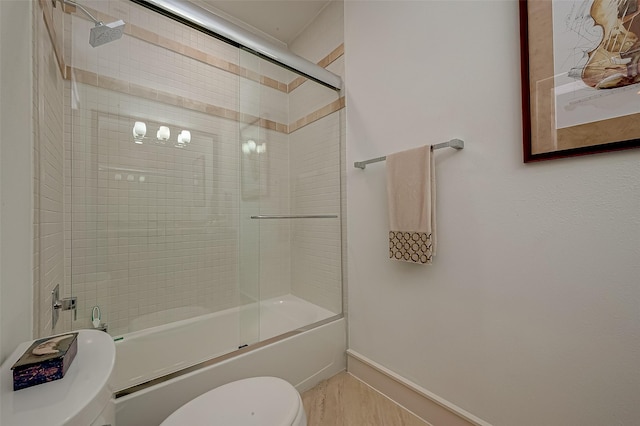 bathroom featuring toilet and enclosed tub / shower combo