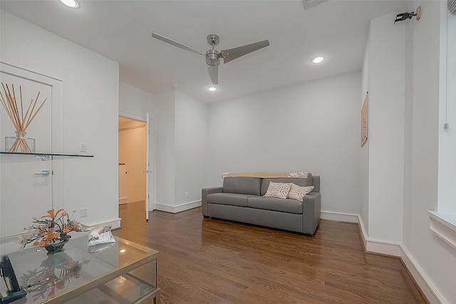 living area with ceiling fan and dark wood-type flooring