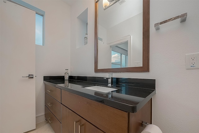 bathroom with plenty of natural light and vanity