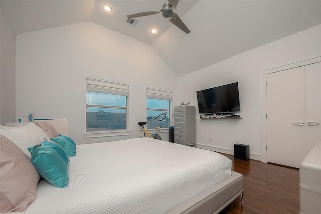 bedroom featuring ceiling fan, a closet, dark wood-type flooring, and lofted ceiling